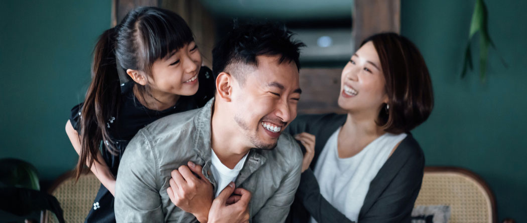 A young family playing in a living room